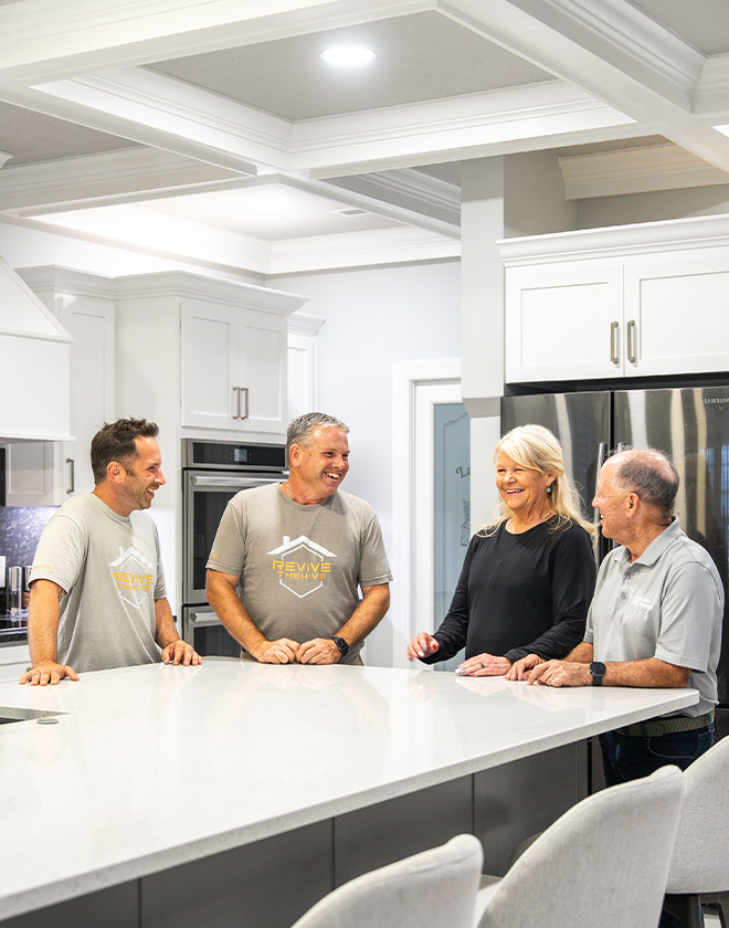 4 people talking in a luxury kitchen